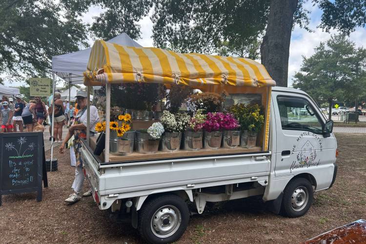 Flower truck with local goods for sale at the Market in the Park in Sunset Beach, NC.