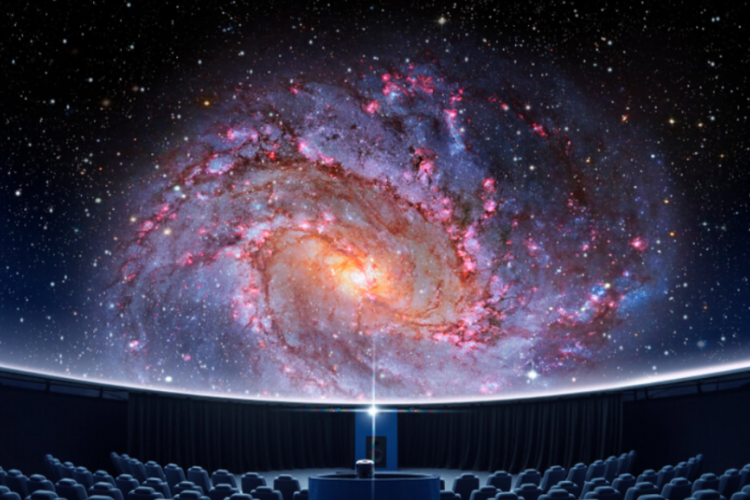 a photo of an audience looking at an image of space