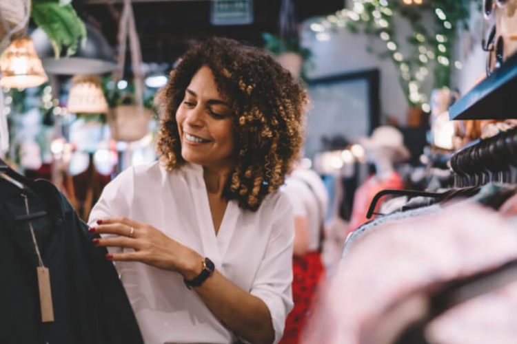 woman admiring a jacket while shopping