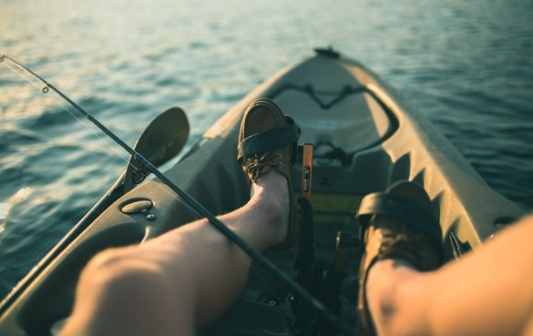 man fishing in kayak | Sunset Vacations