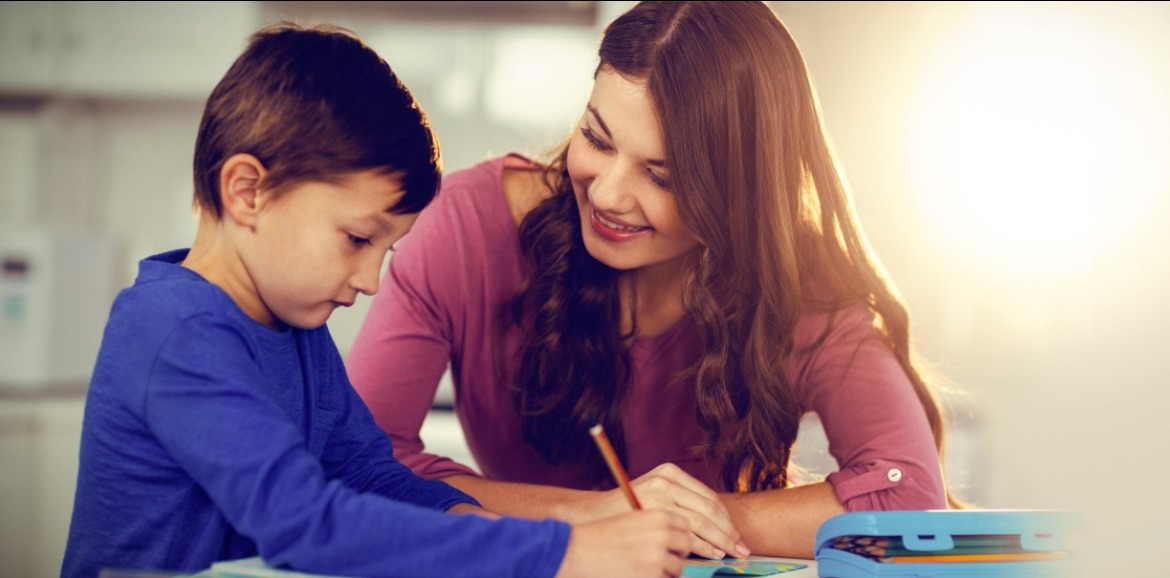 mother watching son write note | Sunset Vacations