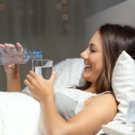 woman pouring water in bed | Sunset Vacations