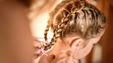 little girl getting her hair braided | Sunset Vacations