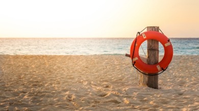 beach with life preserver ring | Sunset Vacations 