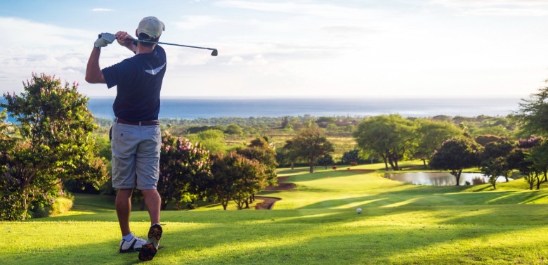 man golfing at the beach | Sunset Vacations