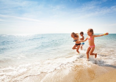 kids playing in the ocean | Sunset Vacations