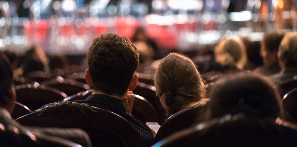 couple watching a show | Sunset Vacations