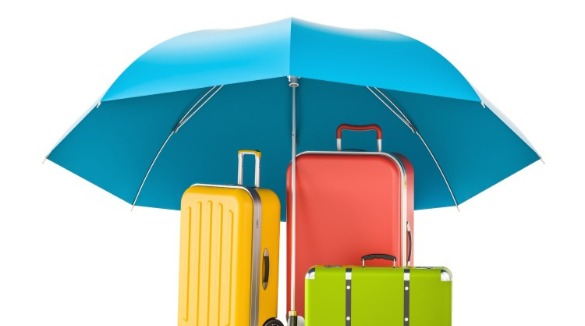 umbrella protecting luggage | Sunset Vacations