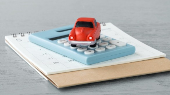  car, calculator, calendar on a table | Sunset Vacations