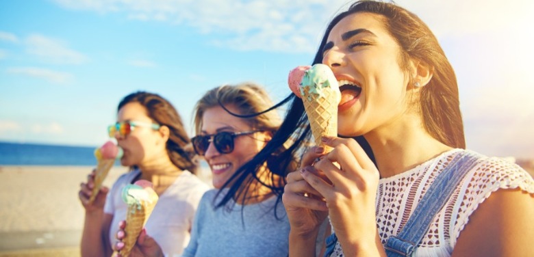 women eating ice cream on the beach | Sunset Vacations